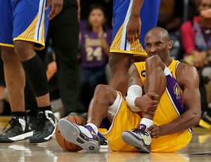 Kobe Bryant writhes in pain on the court late in the game against the Warriors at Staples Center.